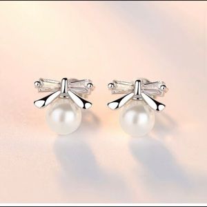 Classic and chic pearl studs with bow detail